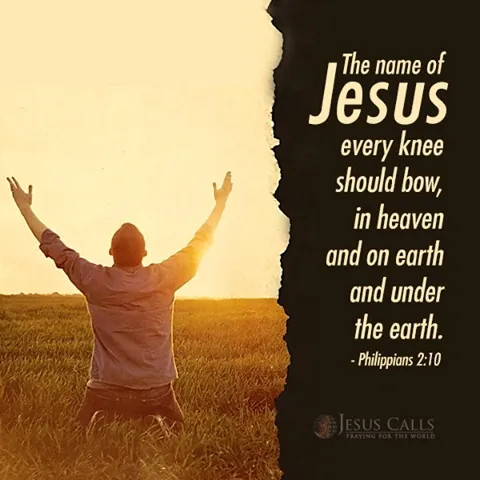 A person kneeling with arms raised in worship