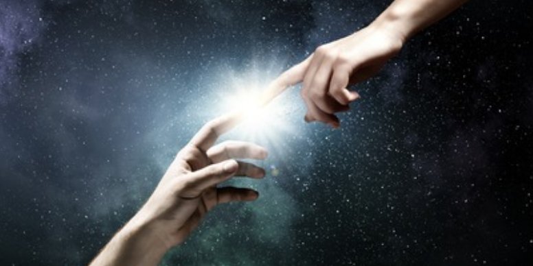 Two hands reaching toward each other through a bright light
